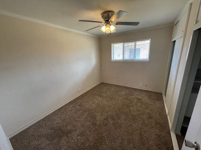 carpeted spare room featuring ornamental molding and ceiling fan