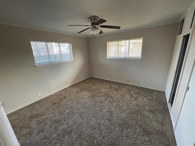 carpeted spare room with crown molding and ceiling fan