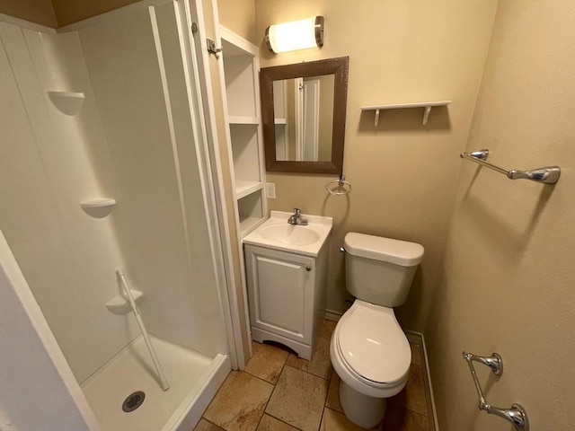 bathroom featuring vanity, walk in shower, and toilet