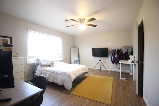 bedroom featuring ceiling fan and dark hardwood / wood-style flooring