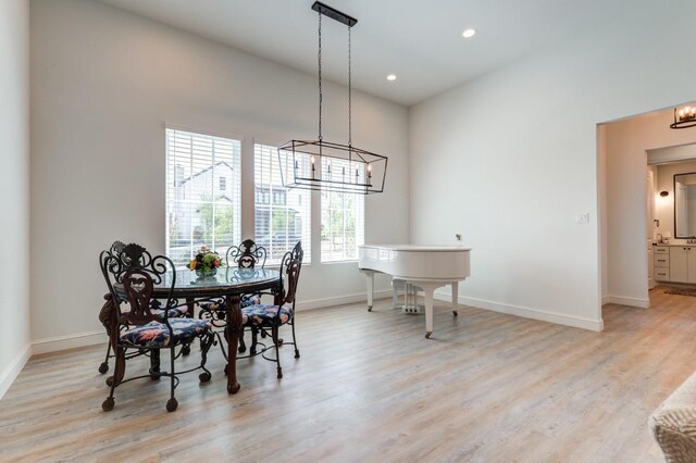 dining area featuring an inviting chandelier and light hardwood / wood-style floors