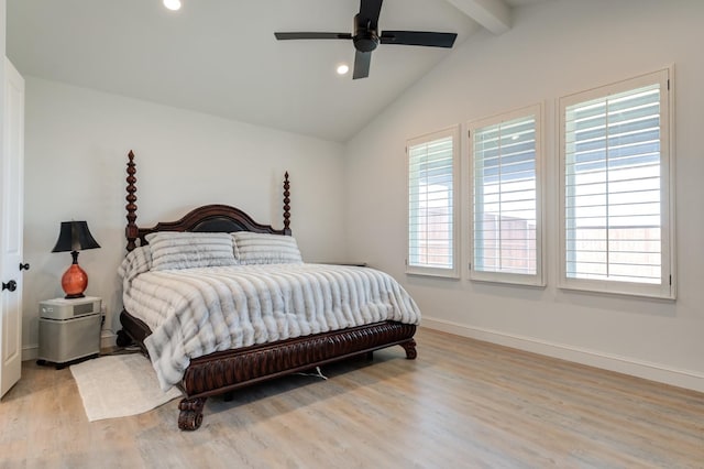 bedroom featuring multiple windows, light hardwood / wood-style flooring, lofted ceiling with beams, and ceiling fan