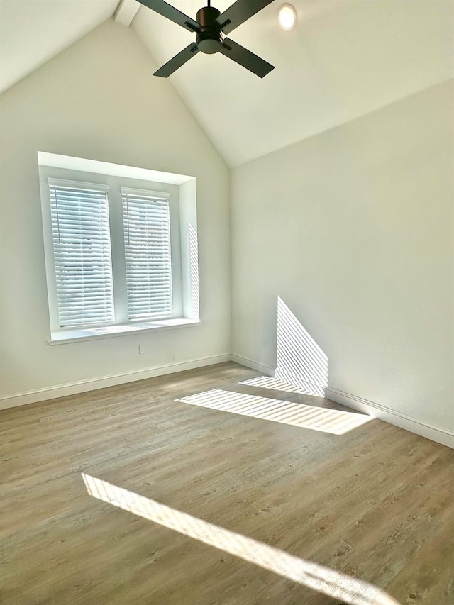 unfurnished room with lofted ceiling, hardwood / wood-style floors, and ceiling fan