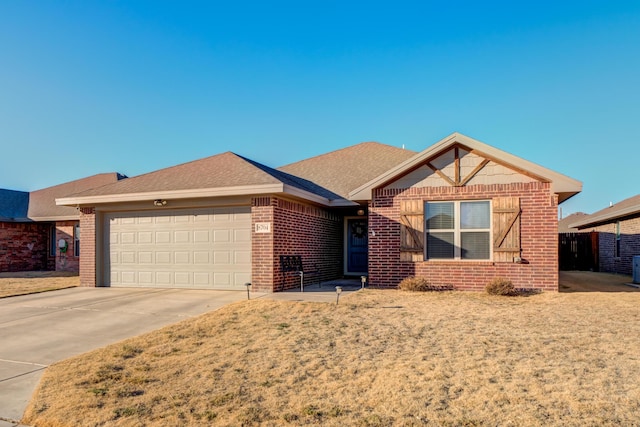 single story home featuring a garage and a front lawn