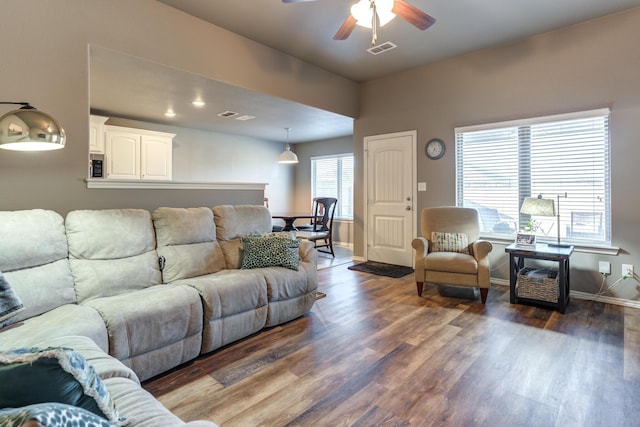 living room with ceiling fan and dark hardwood / wood-style floors