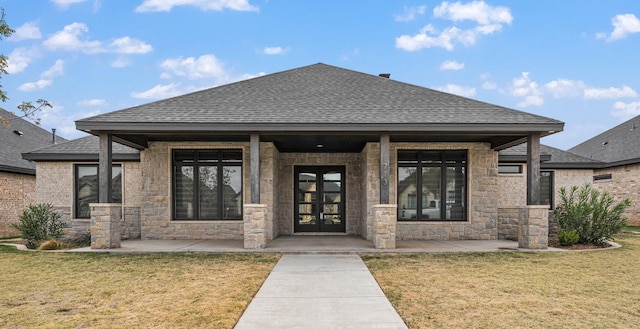 exterior space featuring french doors and a front lawn