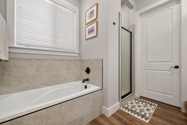 bathroom featuring separate shower and tub and hardwood / wood-style floors