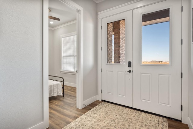 entrance foyer featuring crown molding and light hardwood / wood-style floors