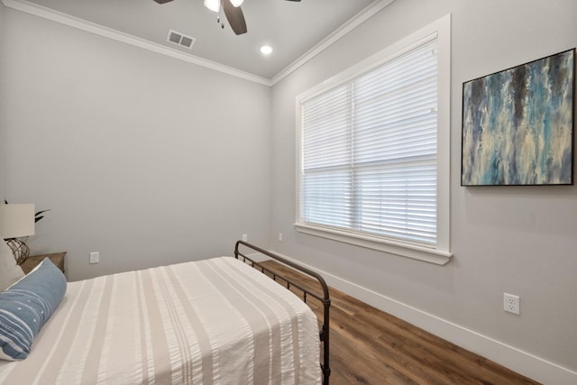 bedroom featuring wood-type flooring, ornamental molding, and ceiling fan