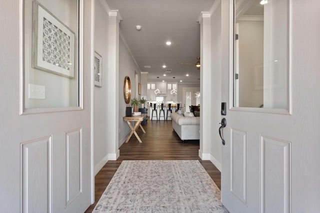 entrance foyer featuring crown molding, dark wood-type flooring, and ceiling fan