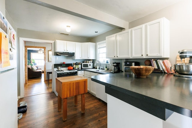 kitchen with white cabinetry, white appliances, wooden counters, and dark hardwood / wood-style floors