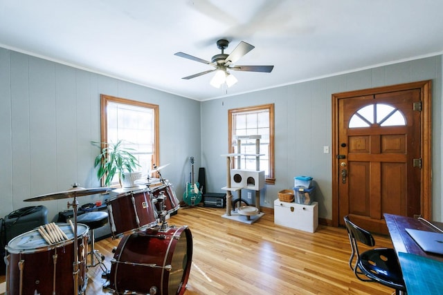 office area with crown molding, ceiling fan, and light wood-type flooring