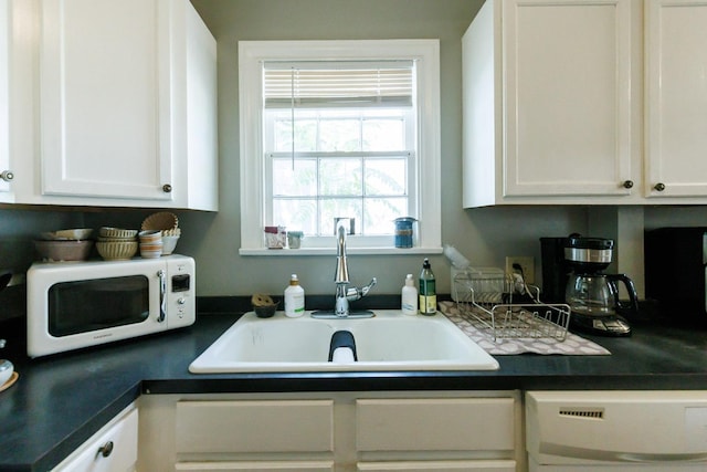 kitchen featuring white cabinetry, sink, and dishwasher