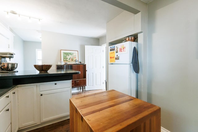 kitchen with white cabinets and white refrigerator