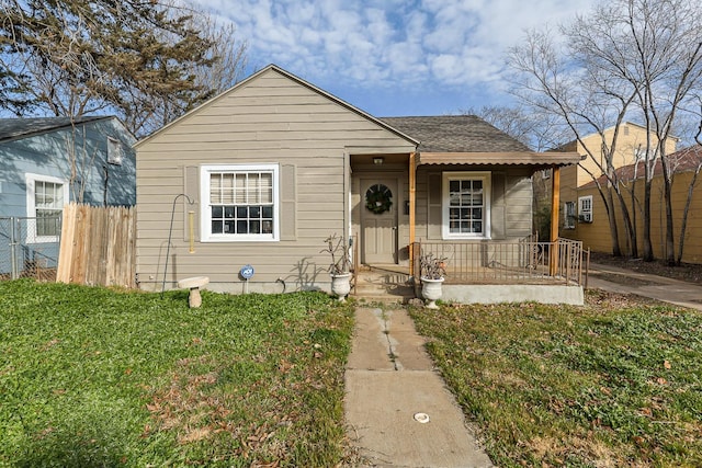 bungalow-style home with a front lawn