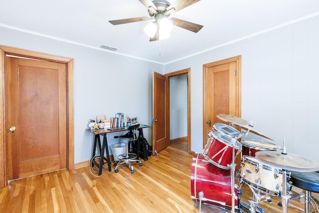 home office with wood-type flooring, ornamental molding, and ceiling fan