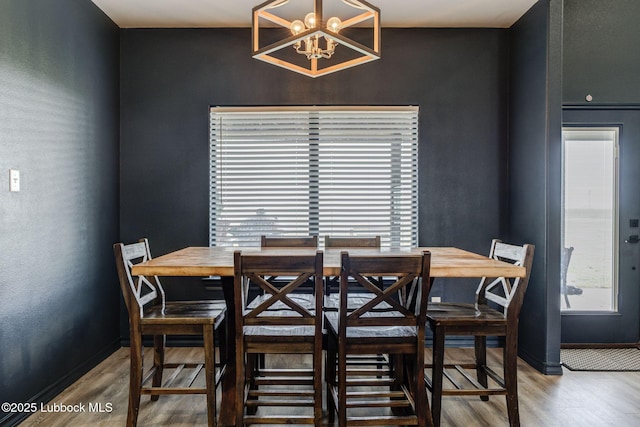 12010 N Crk 1500, Shallowater, TX 79363 - dining space with wood finished floors, a chandelier, and baseboards