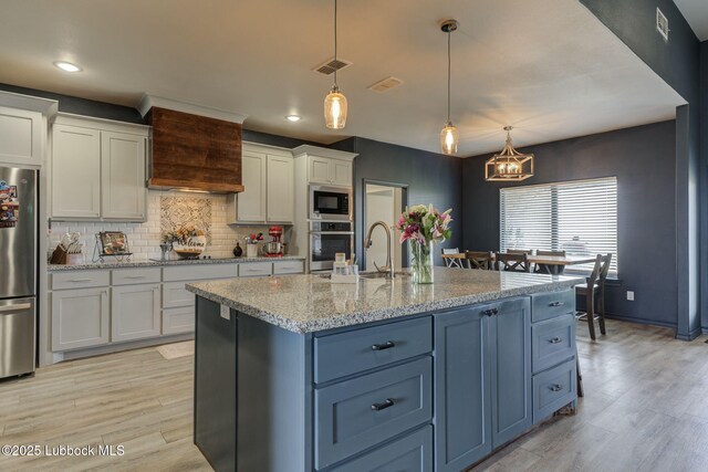 12010 N Crk 1500, Shallowater, TX 79363 - kitchen with stainless steel appliances, white cabinets, a chandelier, light wood-type flooring, and recessed lighting