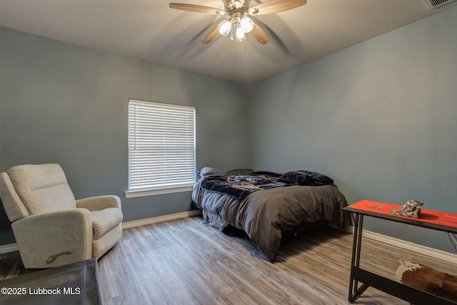 12010 N Crk 1500, Shallowater, TX 79363 - bedroom with baseboards, wood finished floors, and a ceiling fan