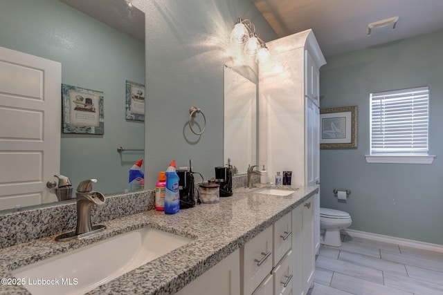 12010 N Crk 1500, Shallowater, TX 79363 - full bathroom with double vanity, toilet, and baseboards