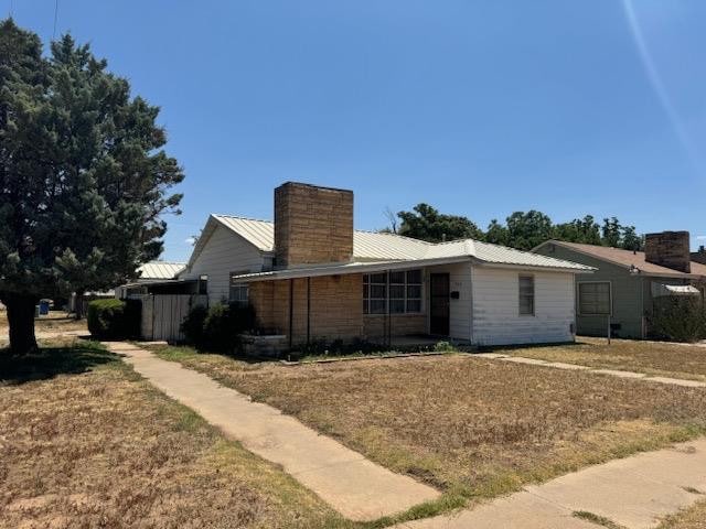 rear view of property featuring a yard