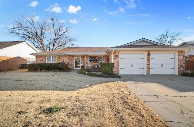 ranch-style house with a garage and central air condition unit