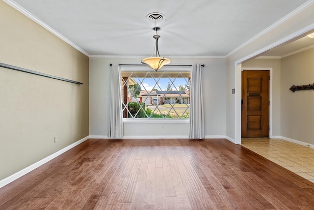 unfurnished dining area with crown molding and wood-type flooring