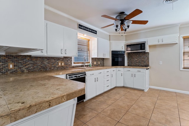 kitchen with sink, crown molding, tasteful backsplash, black appliances, and white cabinets