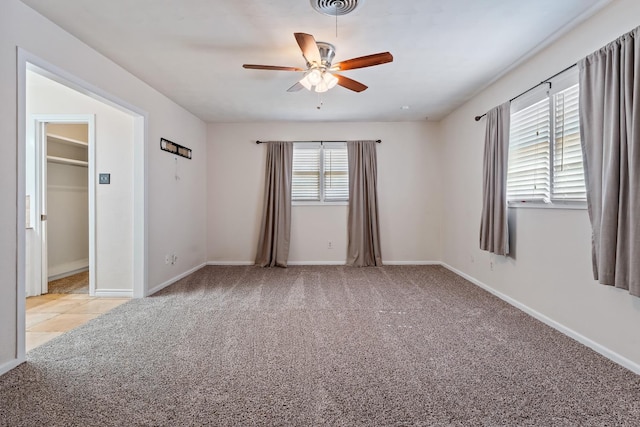 unfurnished bedroom featuring light colored carpet and ceiling fan