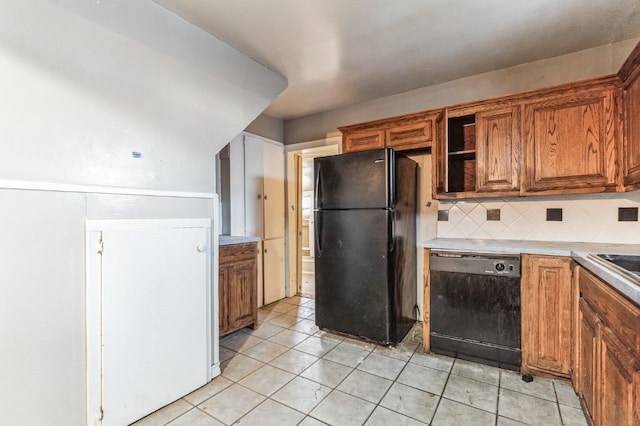 kitchen with tasteful backsplash, light tile patterned floors, and black appliances