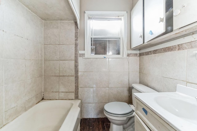 bathroom featuring vanity, toilet, tile walls, and a washtub