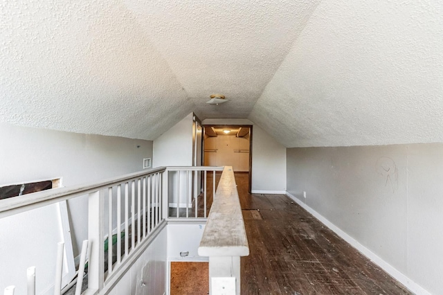 bonus room featuring dark hardwood / wood-style flooring, vaulted ceiling, and a textured ceiling