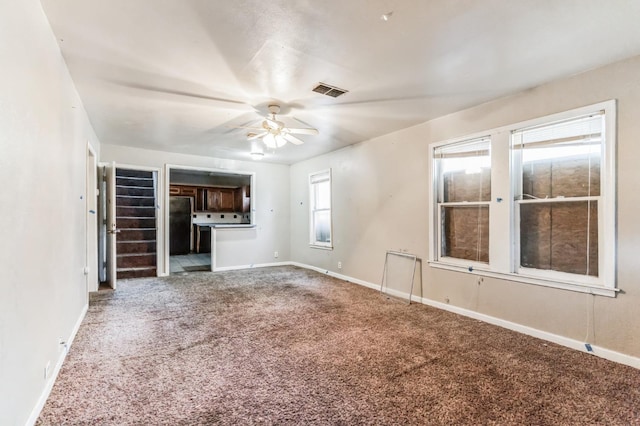 unfurnished living room with carpet floors and ceiling fan