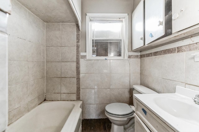 bathroom featuring toilet, vanity, a bath, and tile walls