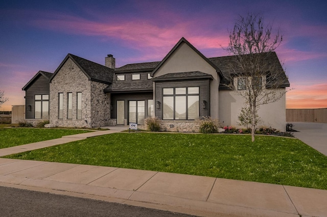 view of front of home with a lawn