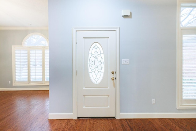 entrance foyer with ornamental molding, hardwood / wood-style floors, and plenty of natural light