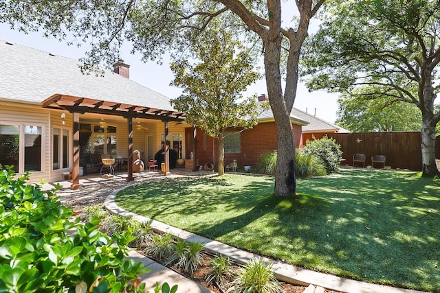 view of yard with ceiling fan and a patio area