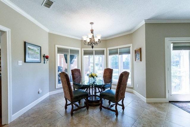 dining room featuring a notable chandelier, ornamental molding, and a textured ceiling