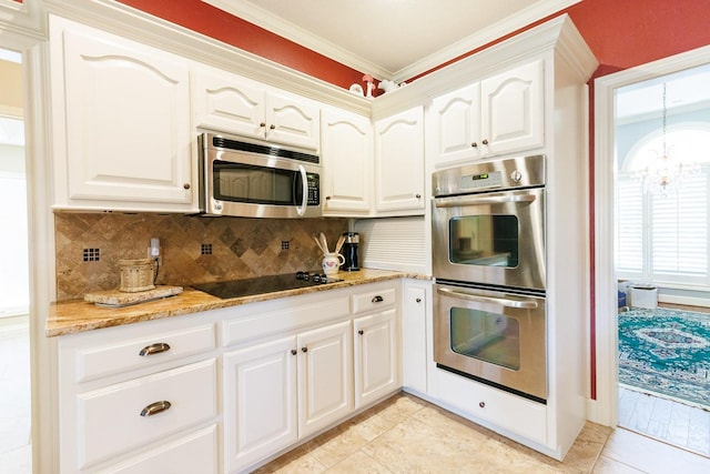 kitchen with appliances with stainless steel finishes, white cabinets, decorative backsplash, ornamental molding, and light stone countertops