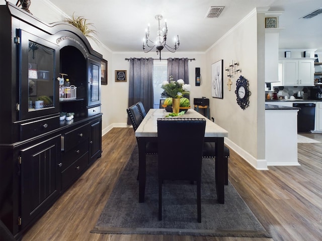 dining room featuring crown molding, dark hardwood / wood-style floors, and a chandelier