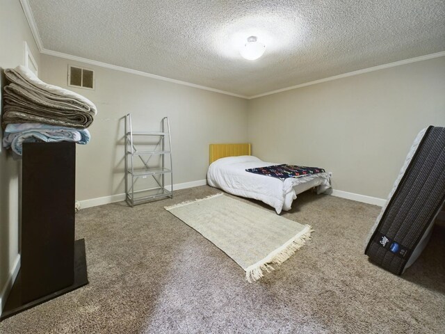 bedroom with crown molding, a textured ceiling, and carpet