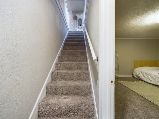 stairs with carpet flooring and a textured ceiling