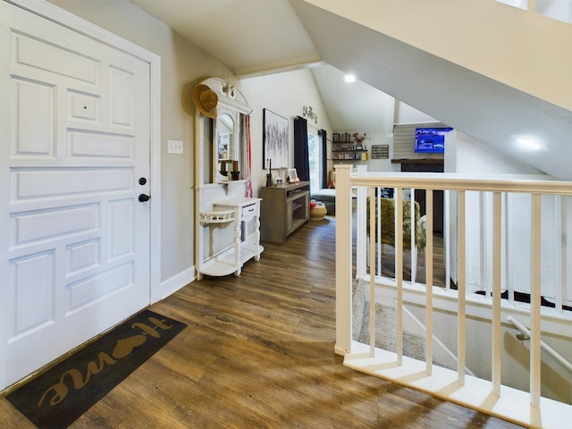 hall featuring dark hardwood / wood-style floors and vaulted ceiling