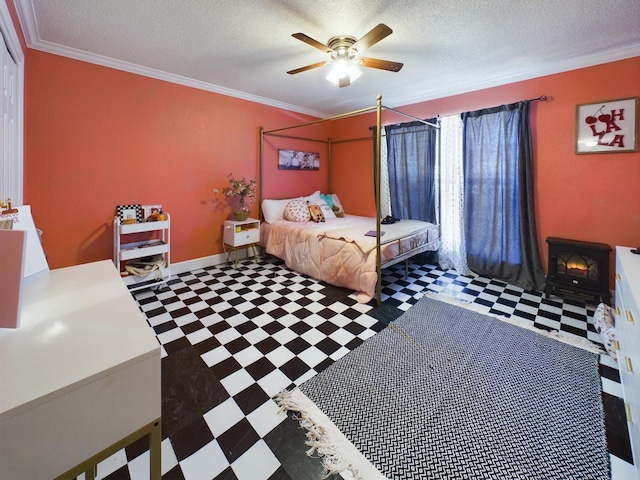 bedroom with ceiling fan, crown molding, and a textured ceiling