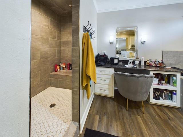 bathroom featuring crown molding, vanity, hardwood / wood-style flooring, and walk in shower