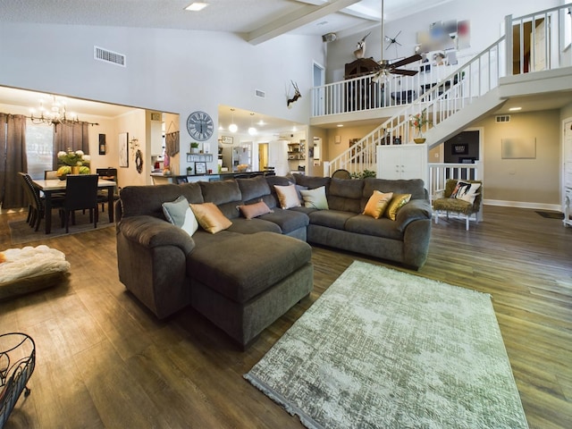 living room with a notable chandelier, dark wood-type flooring, high vaulted ceiling, and beamed ceiling