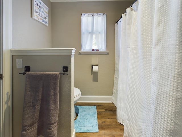 bathroom featuring hardwood / wood-style floors and toilet