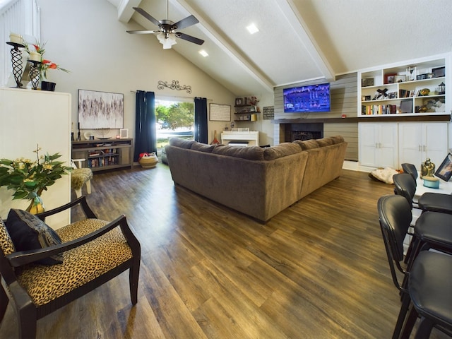 living room with ceiling fan, dark hardwood / wood-style flooring, high vaulted ceiling, and beam ceiling