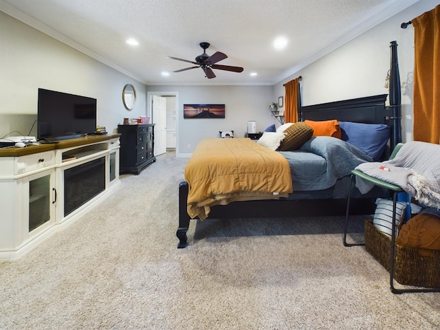 bedroom with ceiling fan, ornamental molding, carpet floors, and a textured ceiling