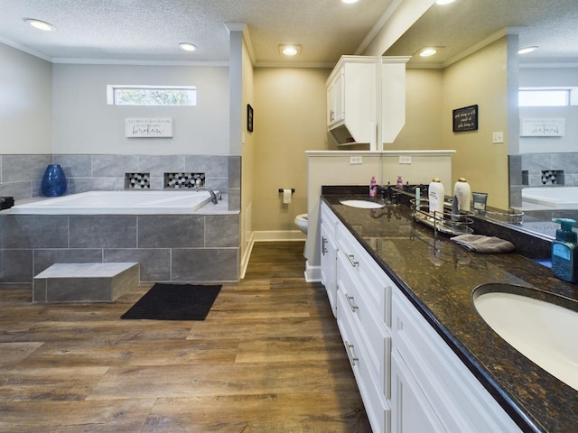 bathroom with vanity, wood-type flooring, a textured ceiling, and toilet